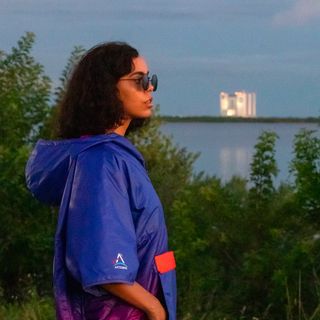 Rumpl's NASA Artemis puffy poncho features the agency's Horizon gradient and logos on a laminated waterproof garment.