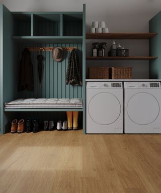 wooden floor in bootility room with laundry appliances and blue open storage and seating area