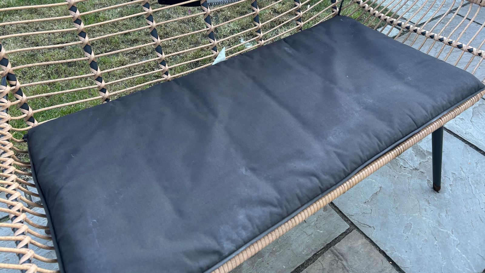 Black garden furniture cushion after cleaning