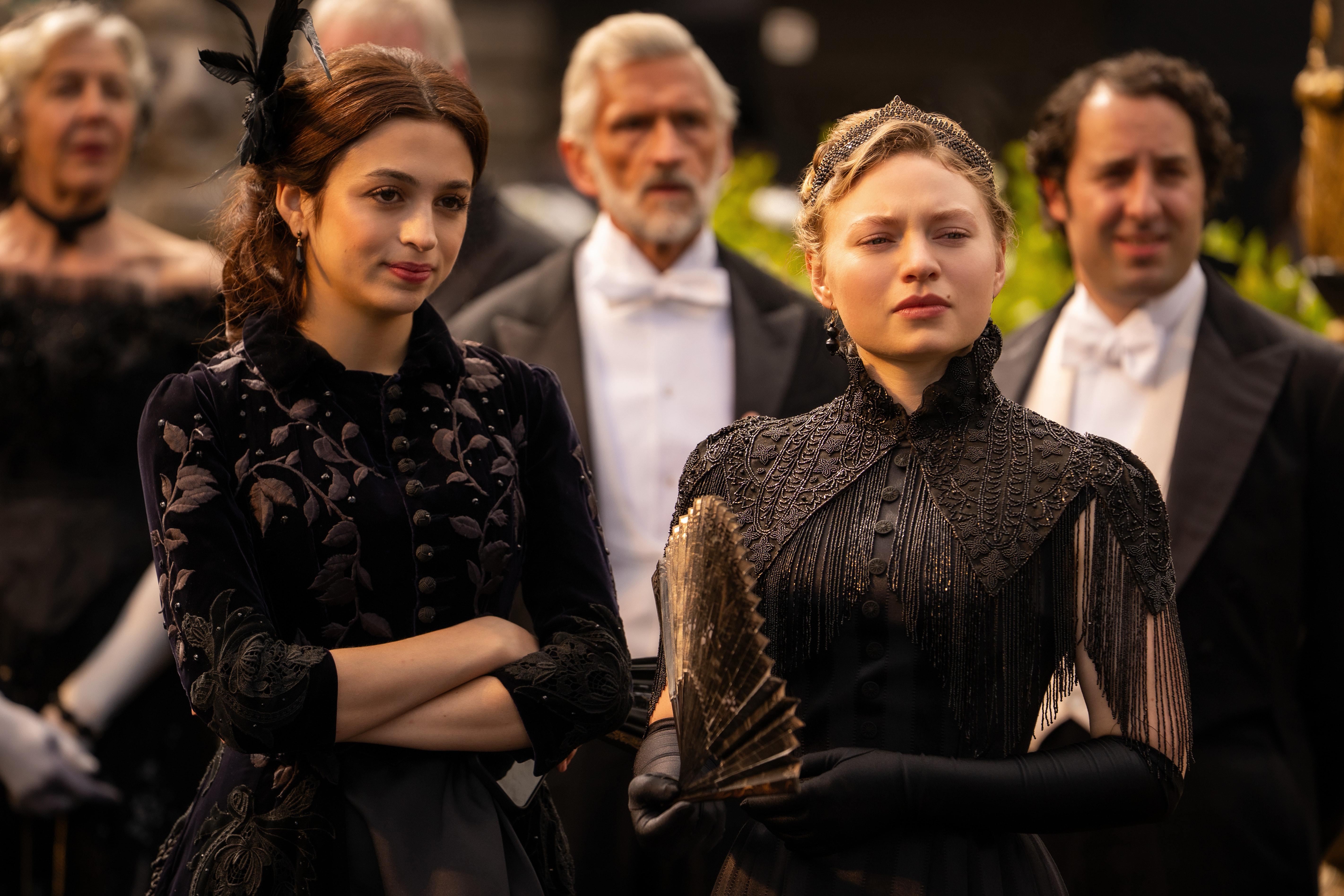 josie totah and mia threapleton wearing black gowns at an event in the buccaneers season 2