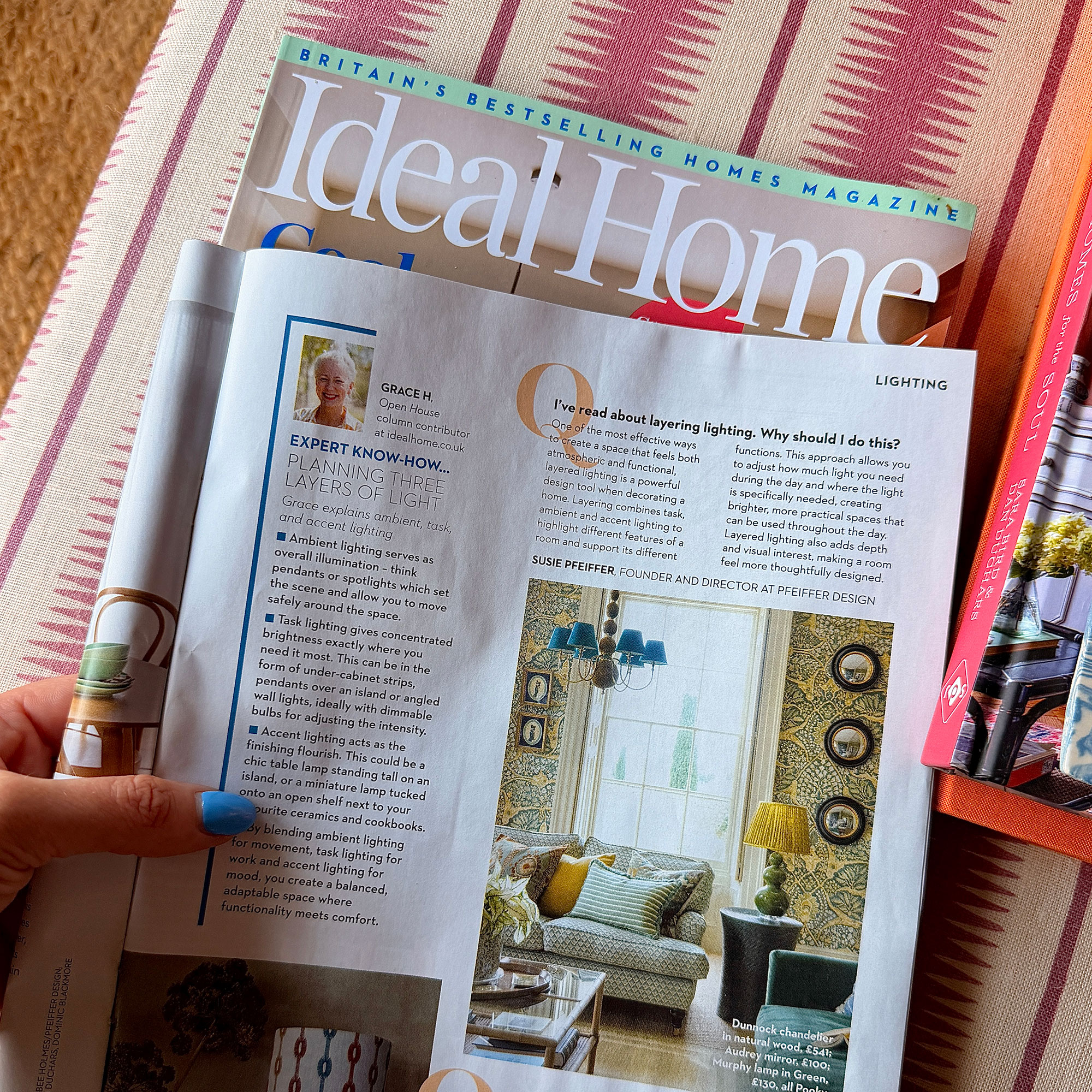 Woman holding open issue of Ideal Home mgazine