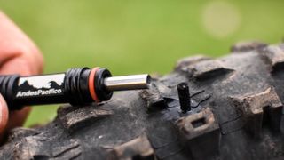Dynaplug Tubeless repair tool being used to fix a mountain bike tire