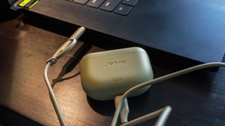 Jabra Elite 8 Active case plugged into laptop.