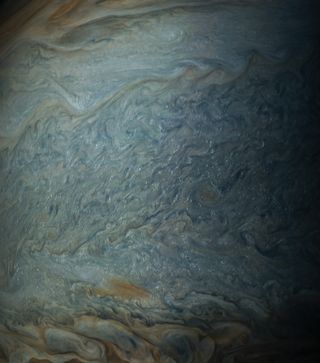 Zoomed-in view of a photo taken by NASA’s Juno probe on May 19, 2017, showing clouds of water ice and/or ammonia ice high up in Jupiter’s atmosphere in the south tropical zone.