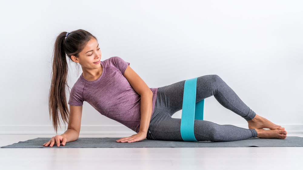 Woman Doing Clamshell Exercises with Resistance Band