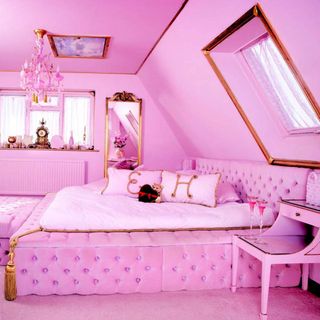 bedroom with pink wall pink bed with cushions