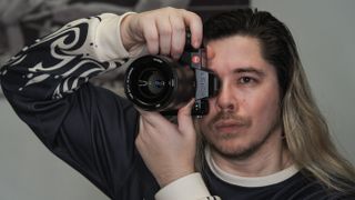 Leica SL3-S on a wooden surface with moody lighting