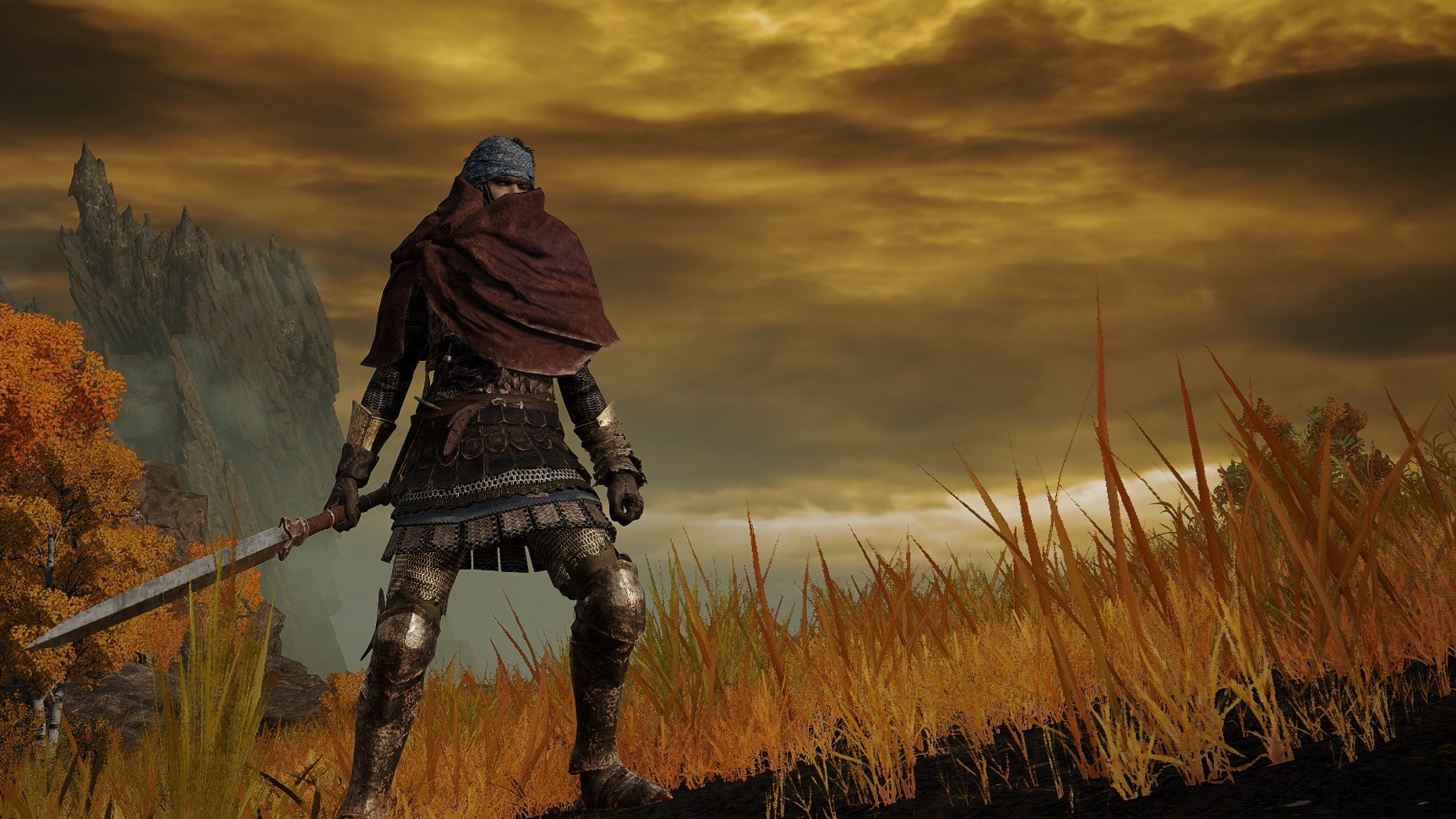A cloaked bandit stands against an orange sky.