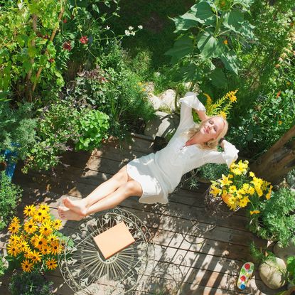 Woman relaxing in patio garden
