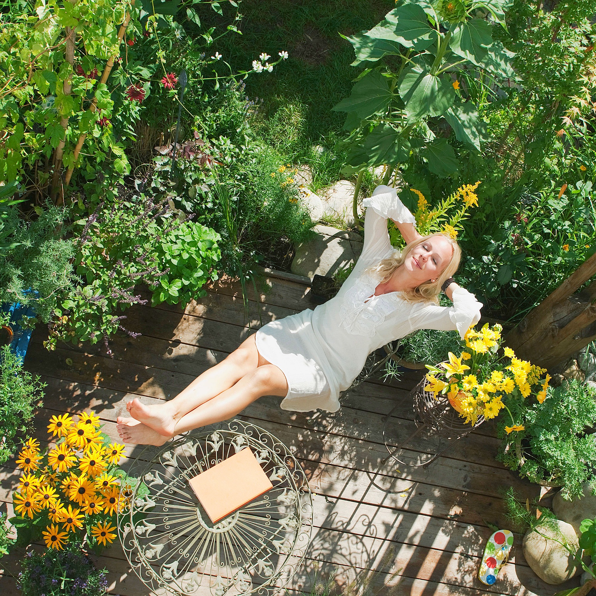 Woman relaxing in patio garden