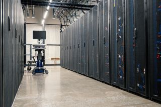 Rows of server racks inside a modern data center