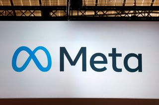 A close up of a large, brightly lit street billboard with the Meta logo displayed