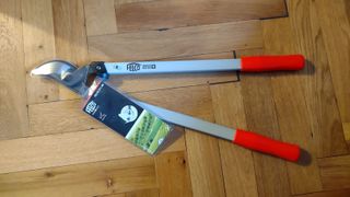 The Felco 211-60 Lopper, placed down on a parquet floor.