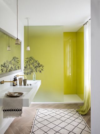 Small bathroom with walk in shower with yellow shower screen