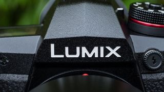 Close-up of the Lumix logo on a Panasonic mirrorless camera