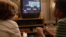 Two boys playing retro video games on a CRT TV