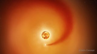 This artist’s concept shows the red supergiant star Betelgeuse and an orbiting companion star. The companion, which is orbiting clockwise from this point of view, generates a dense wake of gas that expands outward.