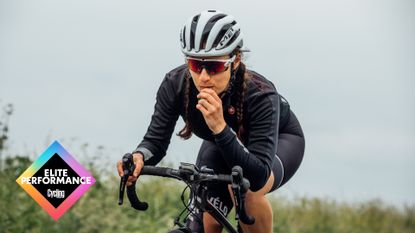 Female cyclist eating a sports nutrition bar on a bike ride