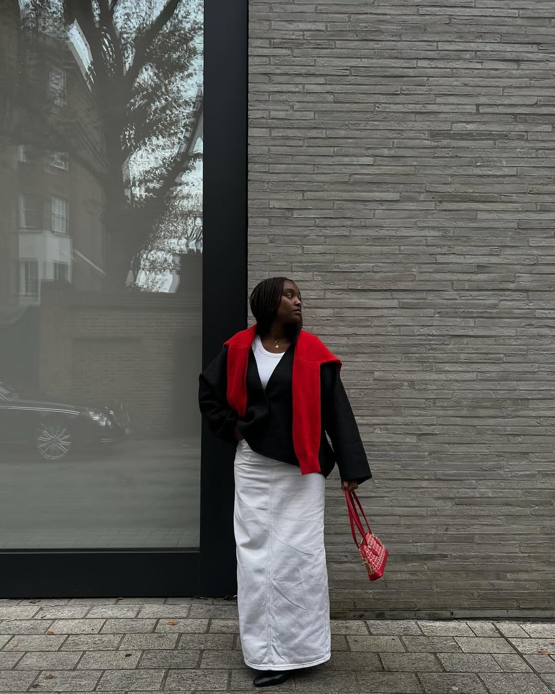 Rebekah in a white skirt with a jacket and red jumper