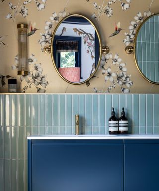 Royal blue vanity unit with pale blue tiles and gold wallpaper