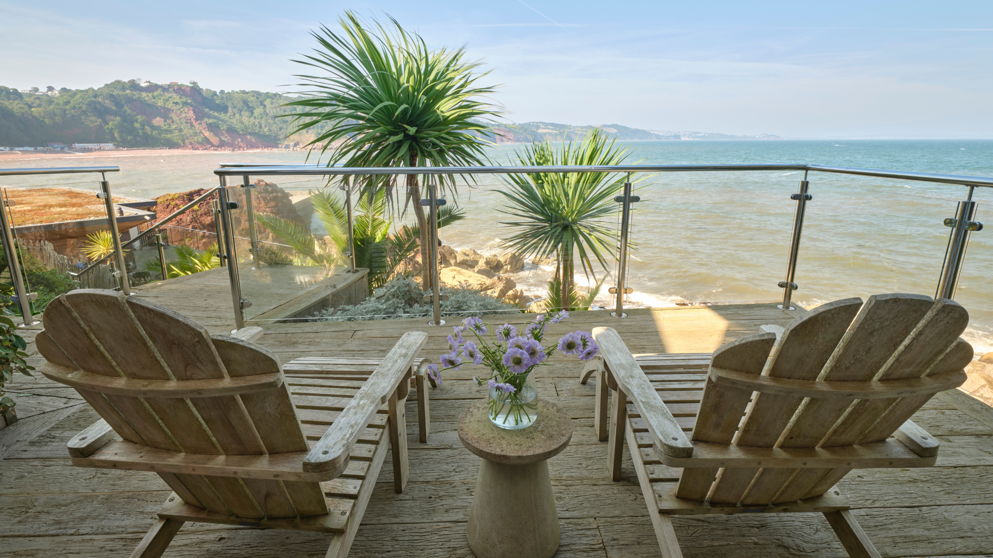 Cary Arms & Spa balcony with chairs looking out to sea.