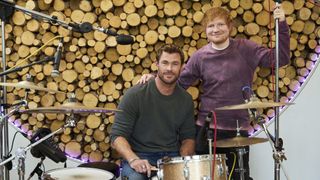 Ed helps Chris learn the drums in Limitless: Live Better Now