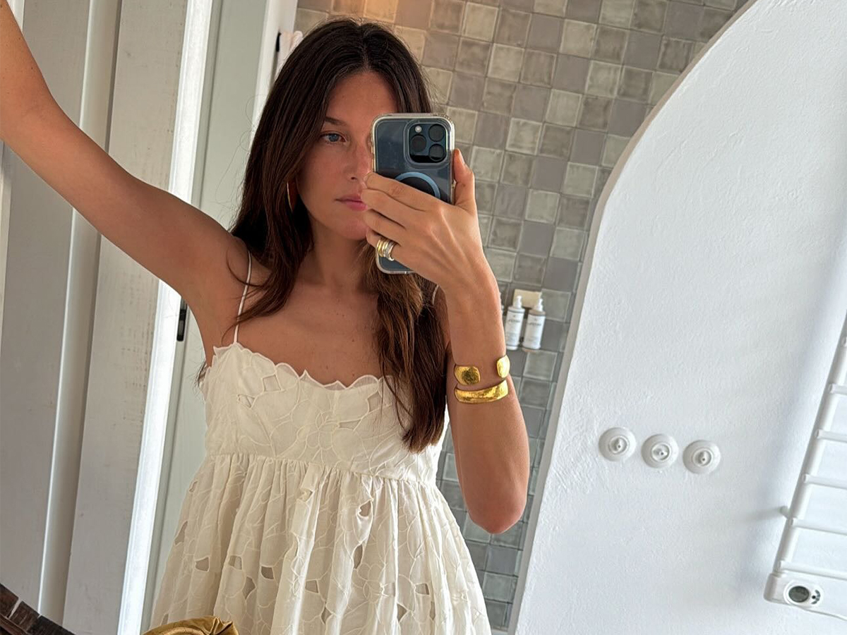 Influencer Sara Ramén wears a white lace dress and a gold bangle.