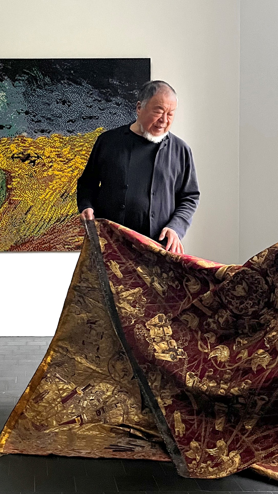 Ai Weiwei with the precious fabric on which Rubelli has reproduced every element of the artist's original design