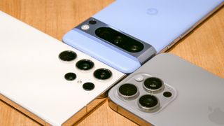 Pixel 8 Pro, iPhone 15 Pro Max, and Galaxy S23 Ultra cameras placed next to each other.