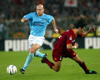 Jaap Stam (left) on the ball for Lazio in a derby against Roma in October 2002.