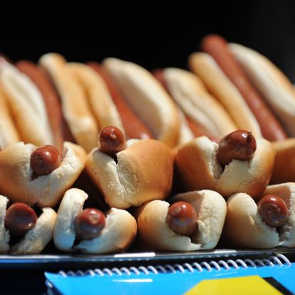 A tray of hotdogs.