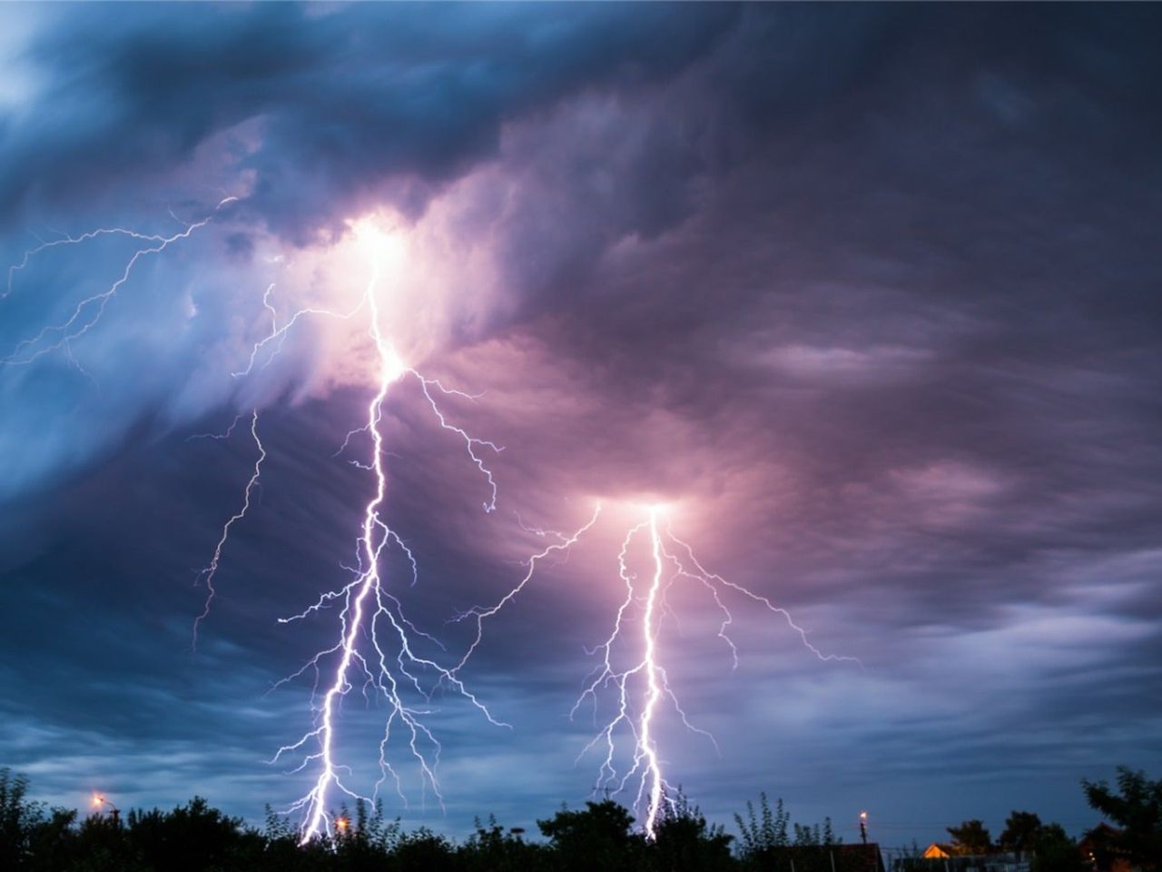 Two bolts of lightning striking the woods