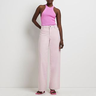 model wearing river island pink wide leg jeans
