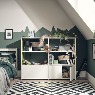 kids bedroom with green geometric mountain style wall and faux plant