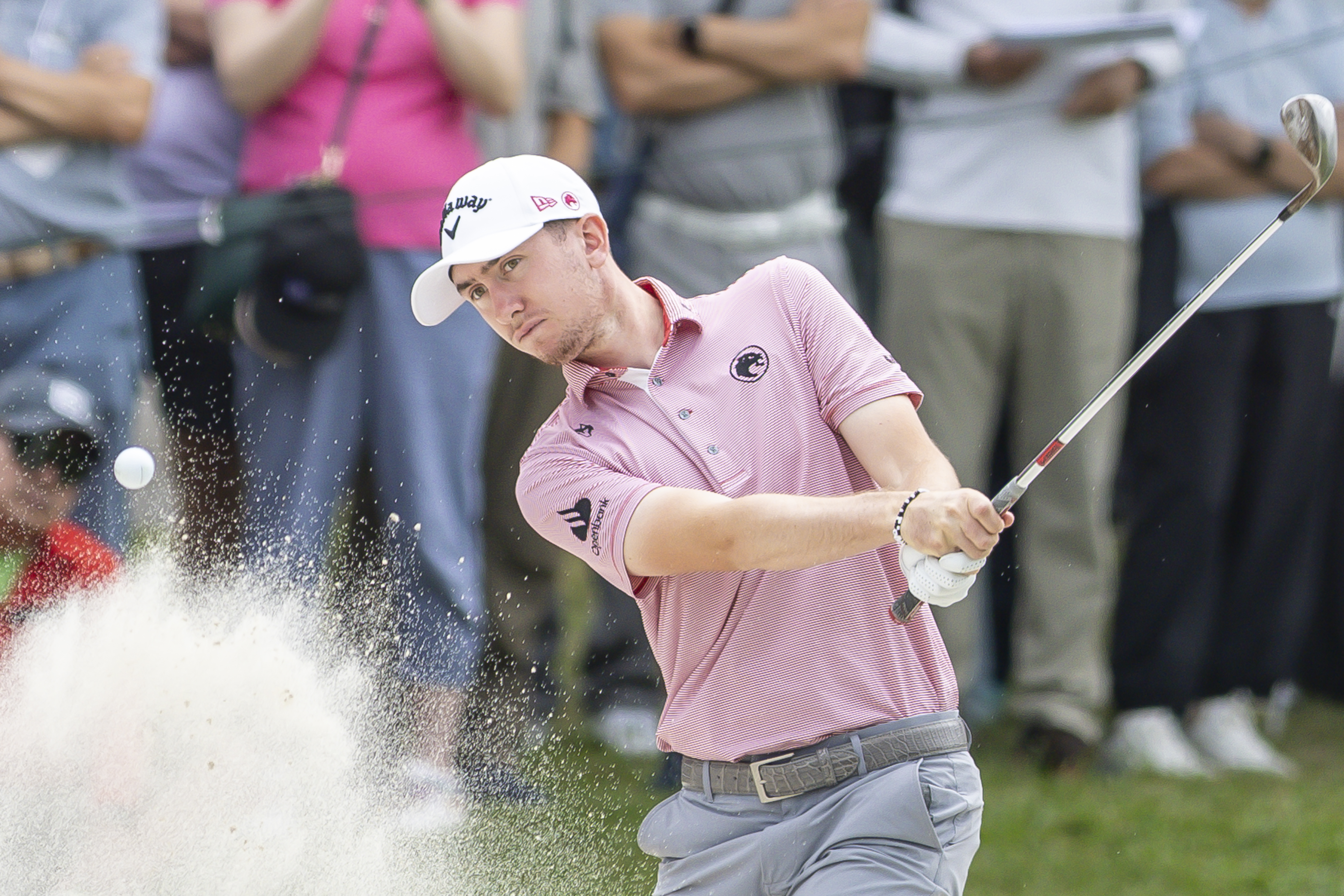 Tom McKibbin hits a bunker shot