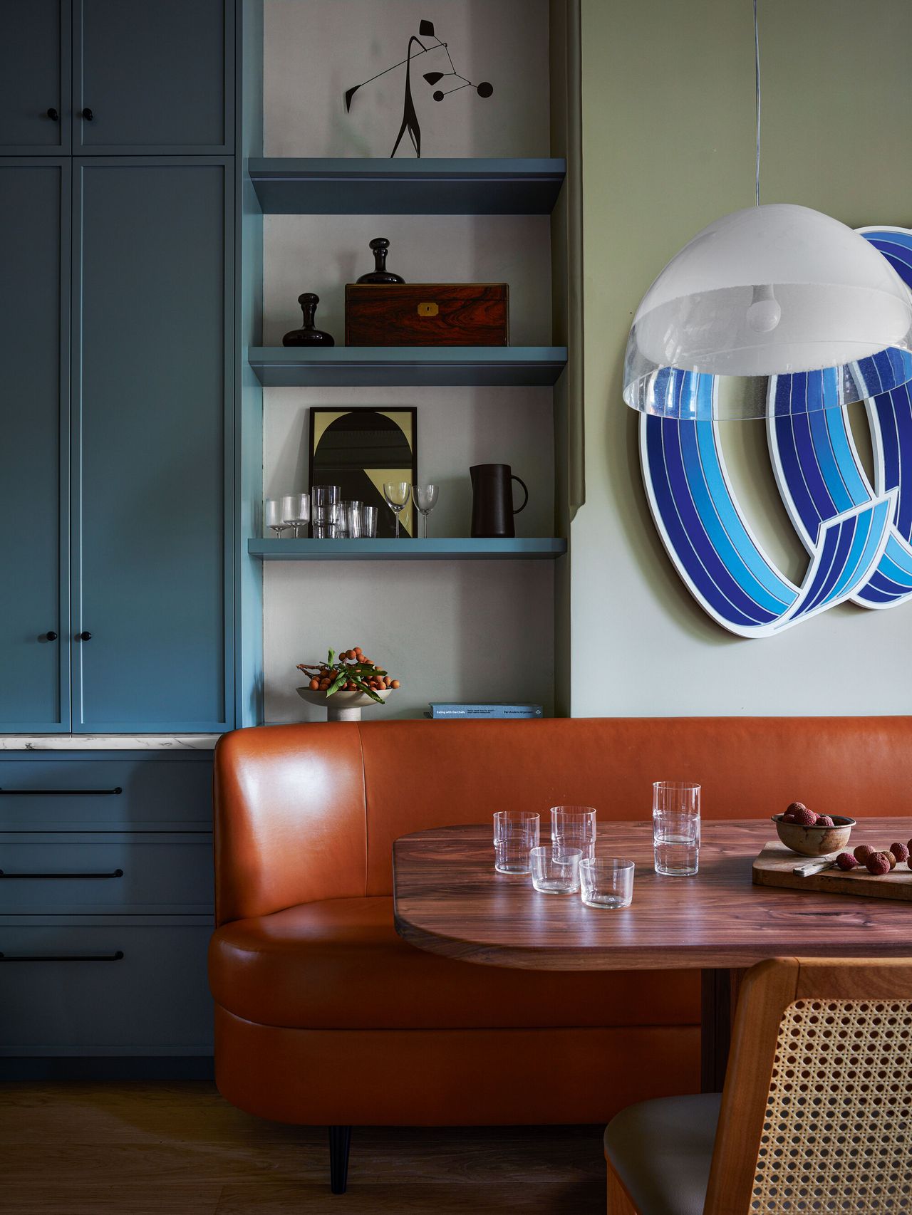 A brown leather curved banquette round the dining table