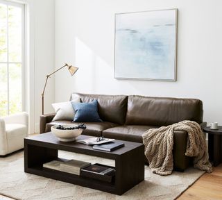 A living room with dark leather sofa