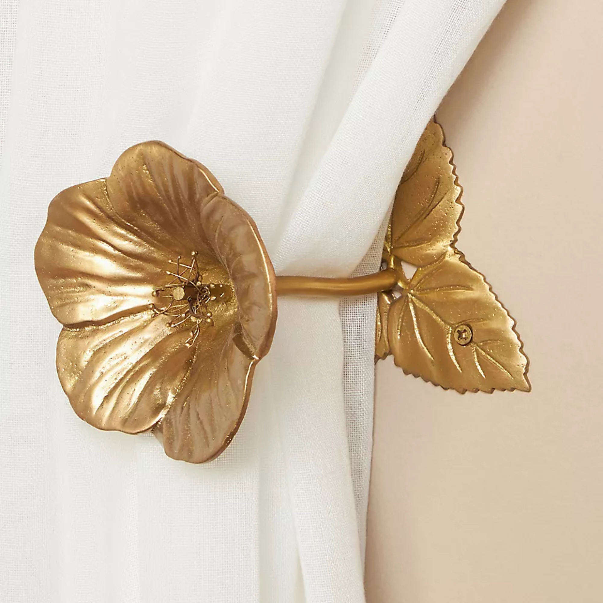 a gold floral curtain tieback