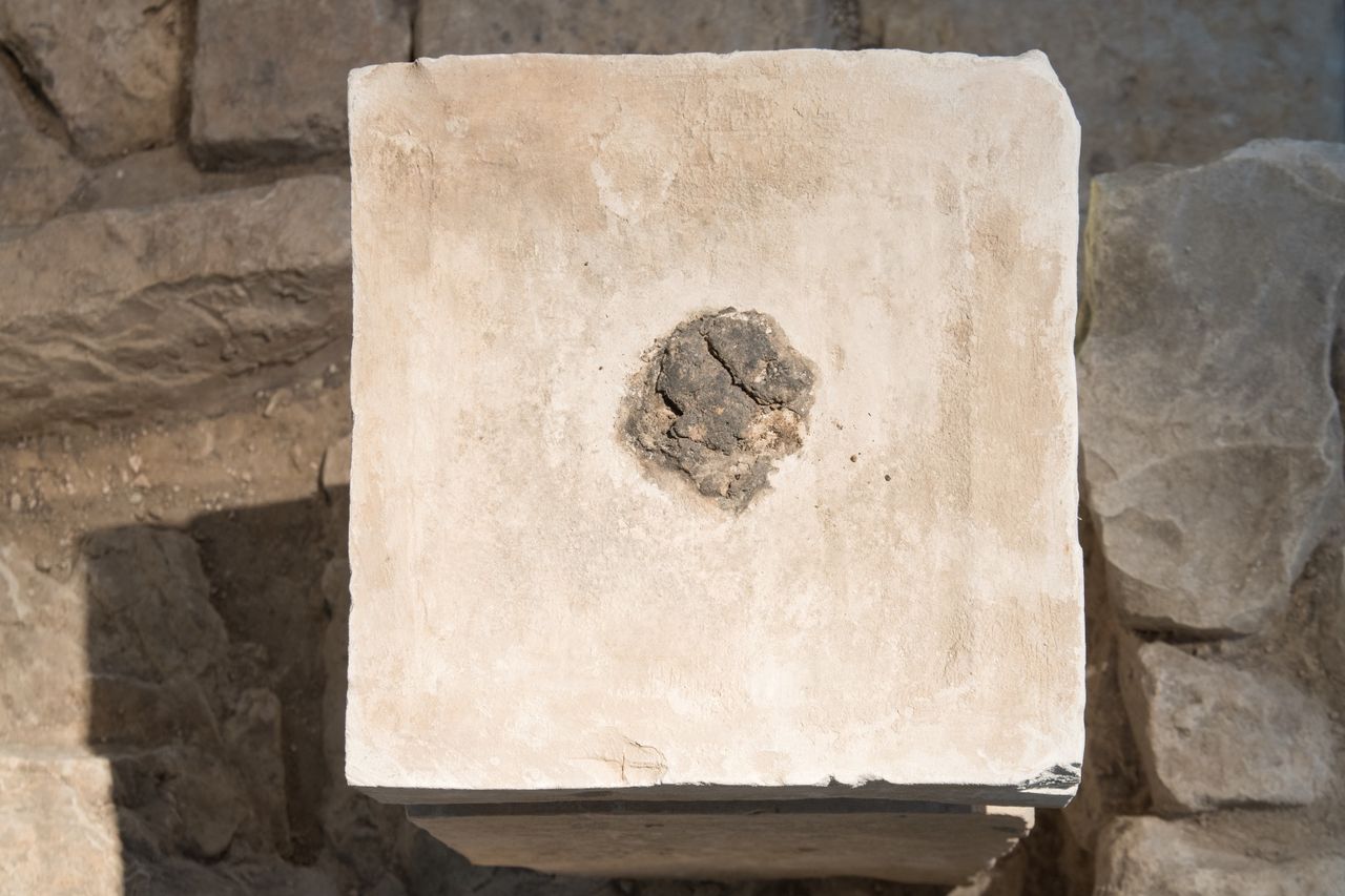 The burnt remnants of the frankincense and animal fat on the taller pillar.