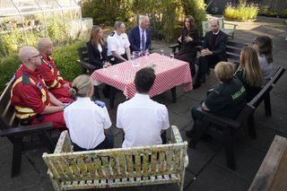 Prince William, Prince of Wales and Britain's Catherine, Princess of Wales speak to members of the emergency services during a visit to Southport Community Centre in Southport, north west England on October 10, 2024, where they met rescue workers and the families of those caught up in the Southport knife attack earlier this year.