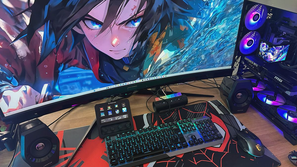 Midas' desk, showing a monitor, gaming pc, keyboard, and mouse