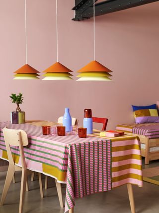 Ikea and Raw Color collaboration: table with colourful tablecloth, carafes, glassware and lighting, from the Ikea Tesammans collection