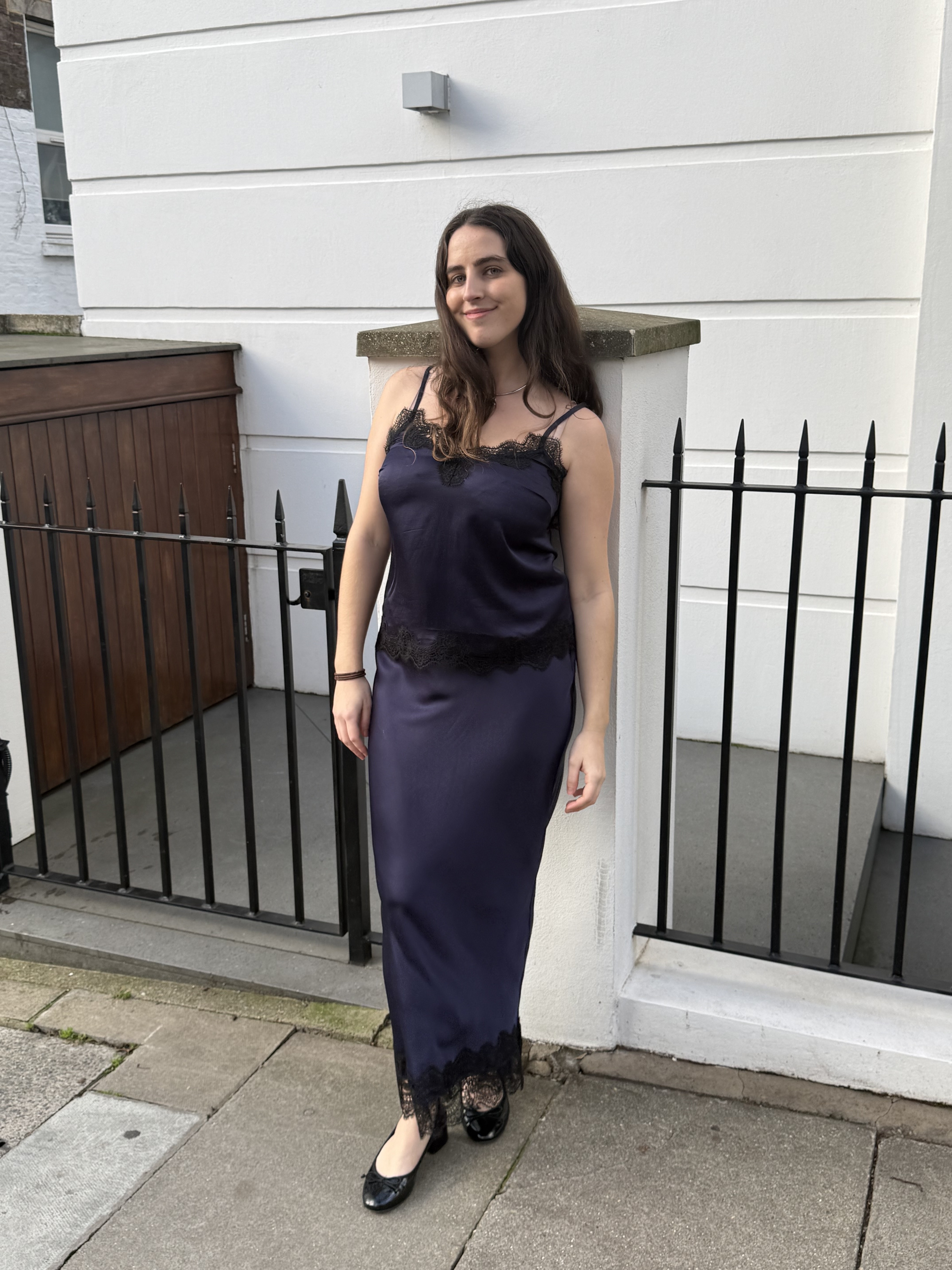 An image of Who What Wear writer Ava Gilchrist wearing an Aligne satin skirt.