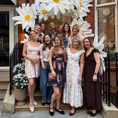 Natasha Archer and a group of women posing in front of a store
