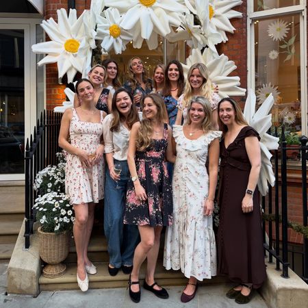 Natasha Archer and a group of women posing in front of a store