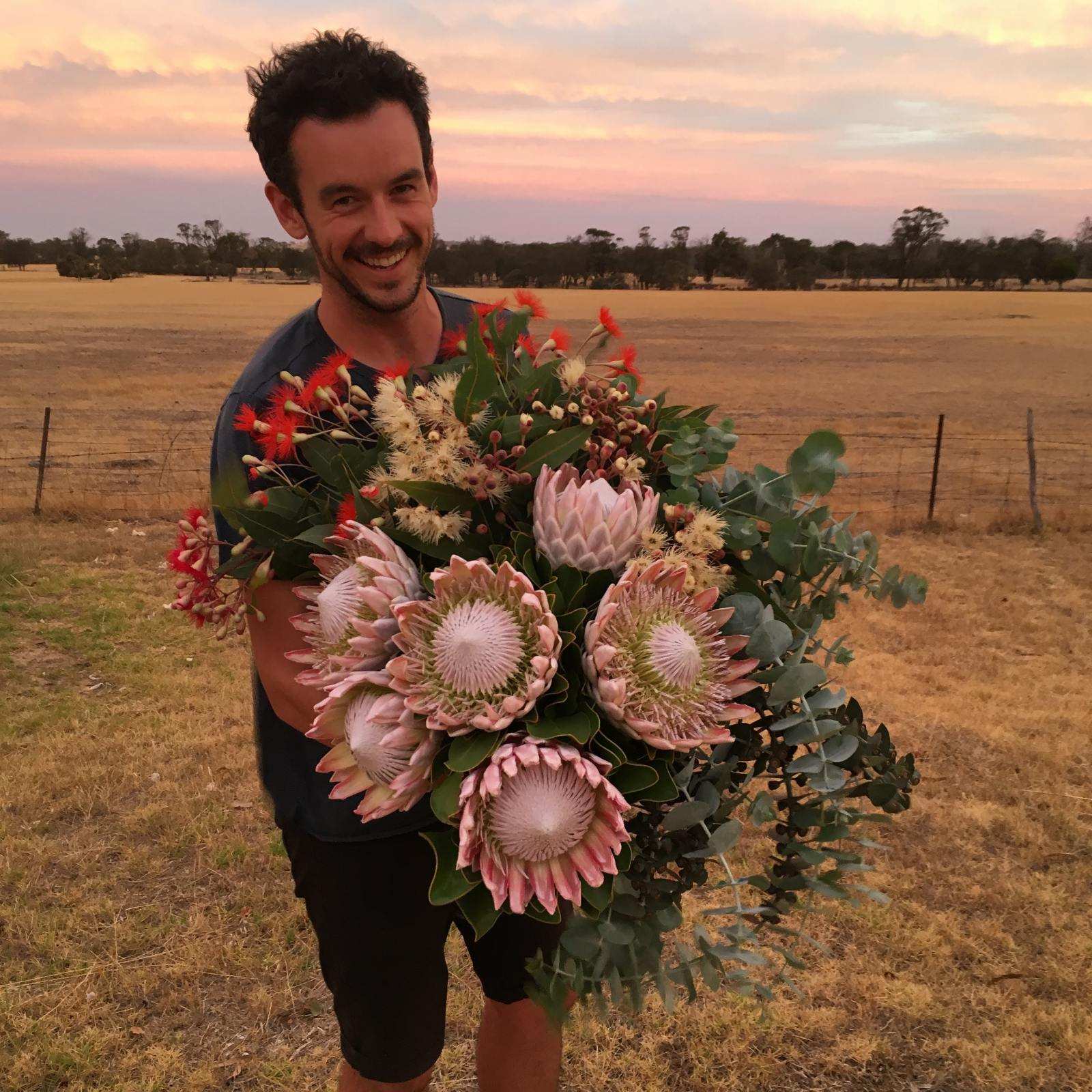 Bobby Bowen from Farmer Bailey holding a large bunch of flowers