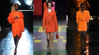 Models in orange on the runway