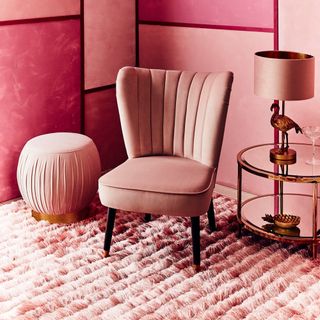 living room with pink wall and pink chair