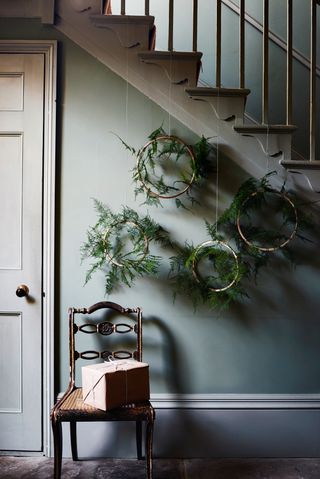 Minimalist wreaths hanging in a hallway