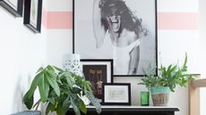 Debbie Goodwin: landing nook with console table, black and white photograph of woman, white walls with pink horizontal stripe paint effect